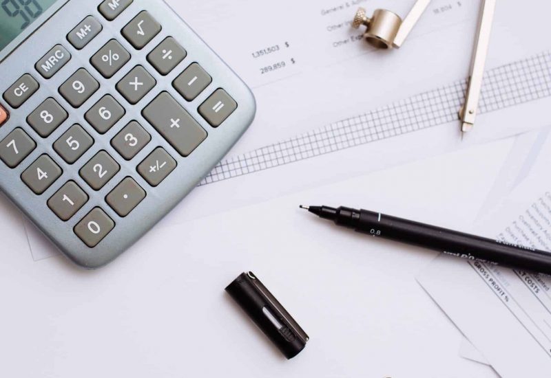 A close up shot business study essentials on a white desk - work and study aesthetics